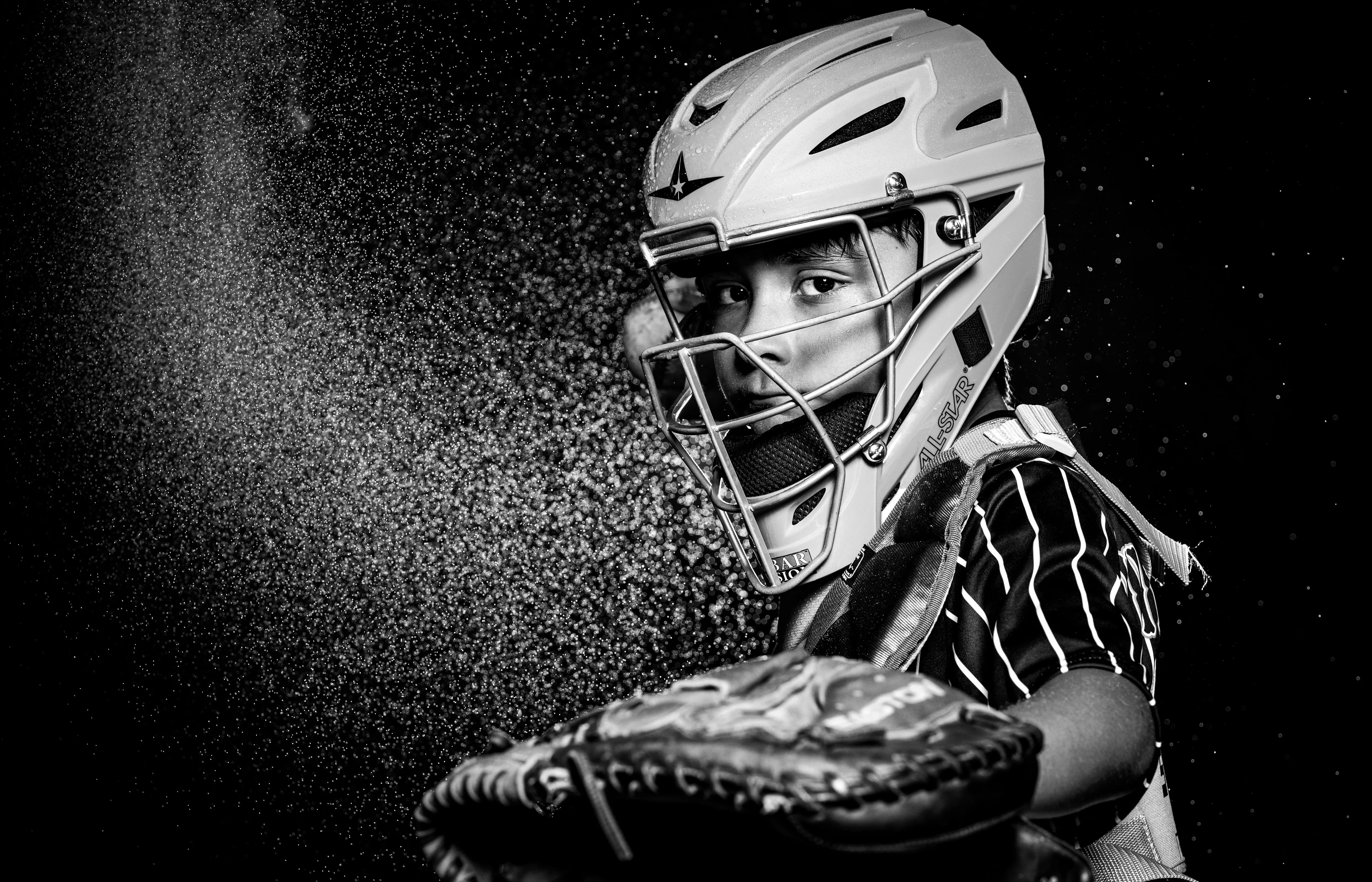 Baseball catcher throwing through a burst of orange powder, dramatic action portrait